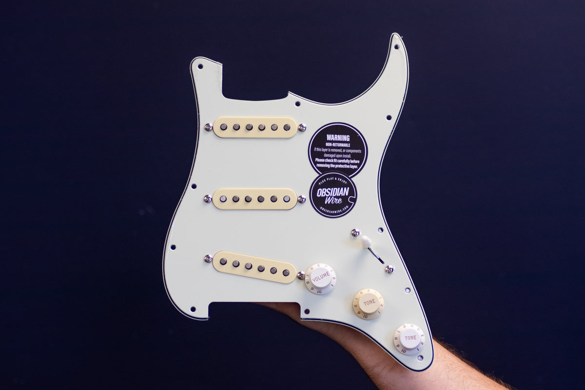 McCready Loaded Pickguard for Stratocaster using mint green pickguard and mixed aged white & parchment knobs & pickup covers.